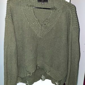 green ripped sweater